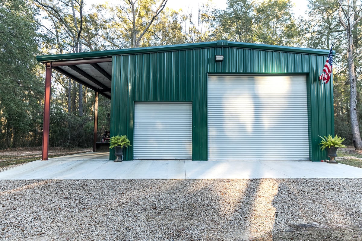 Metal carport building for covered car storage on a residential property