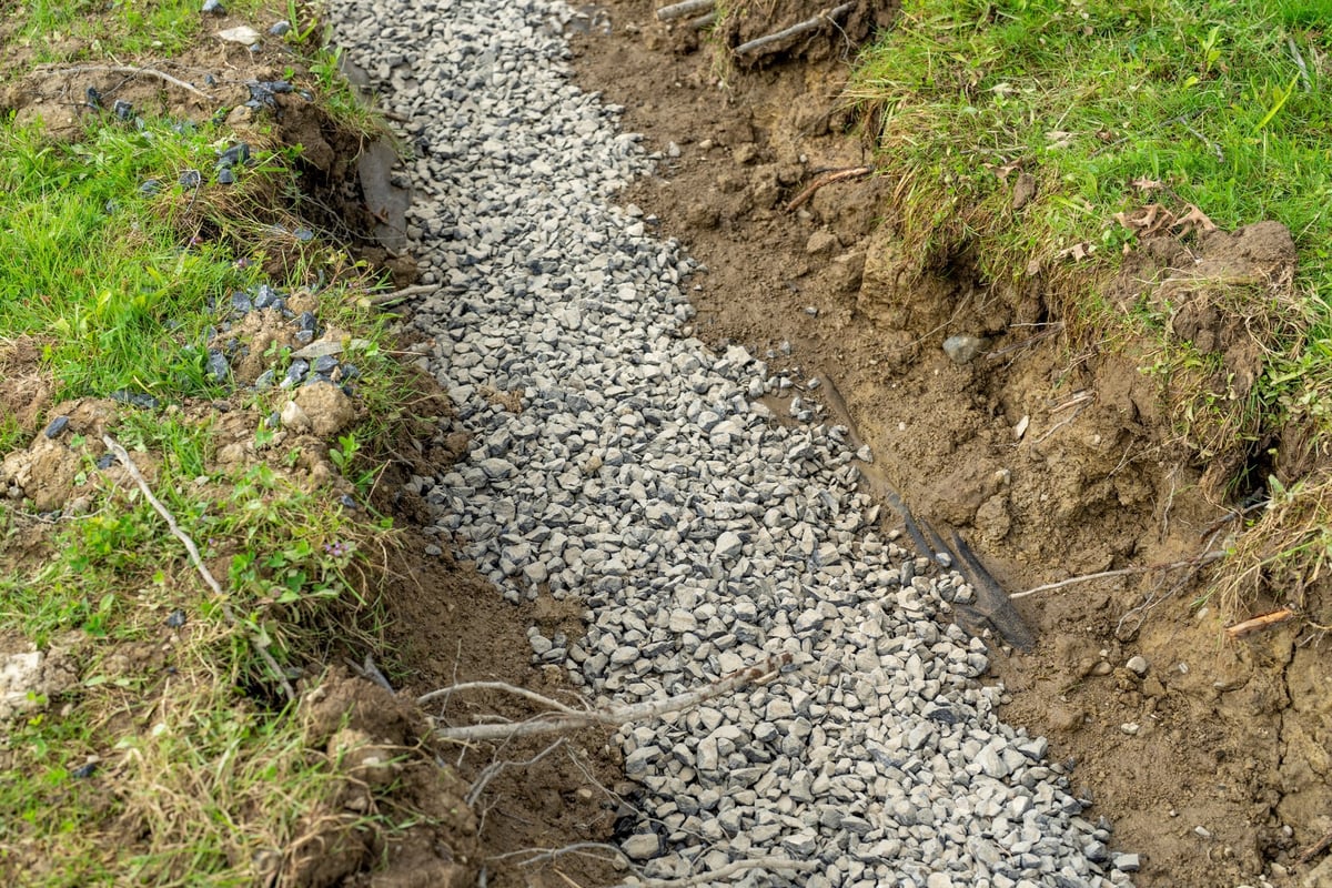 Stone French drain, under drain to mitigate storm water ground water.