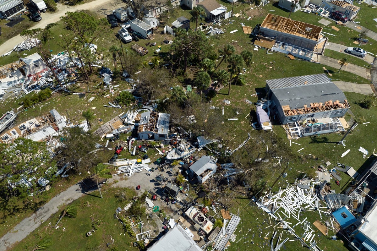 Strong hurricane winds severely damaged private houses in Florida mobile home residential area. Consequences of natural disaster.