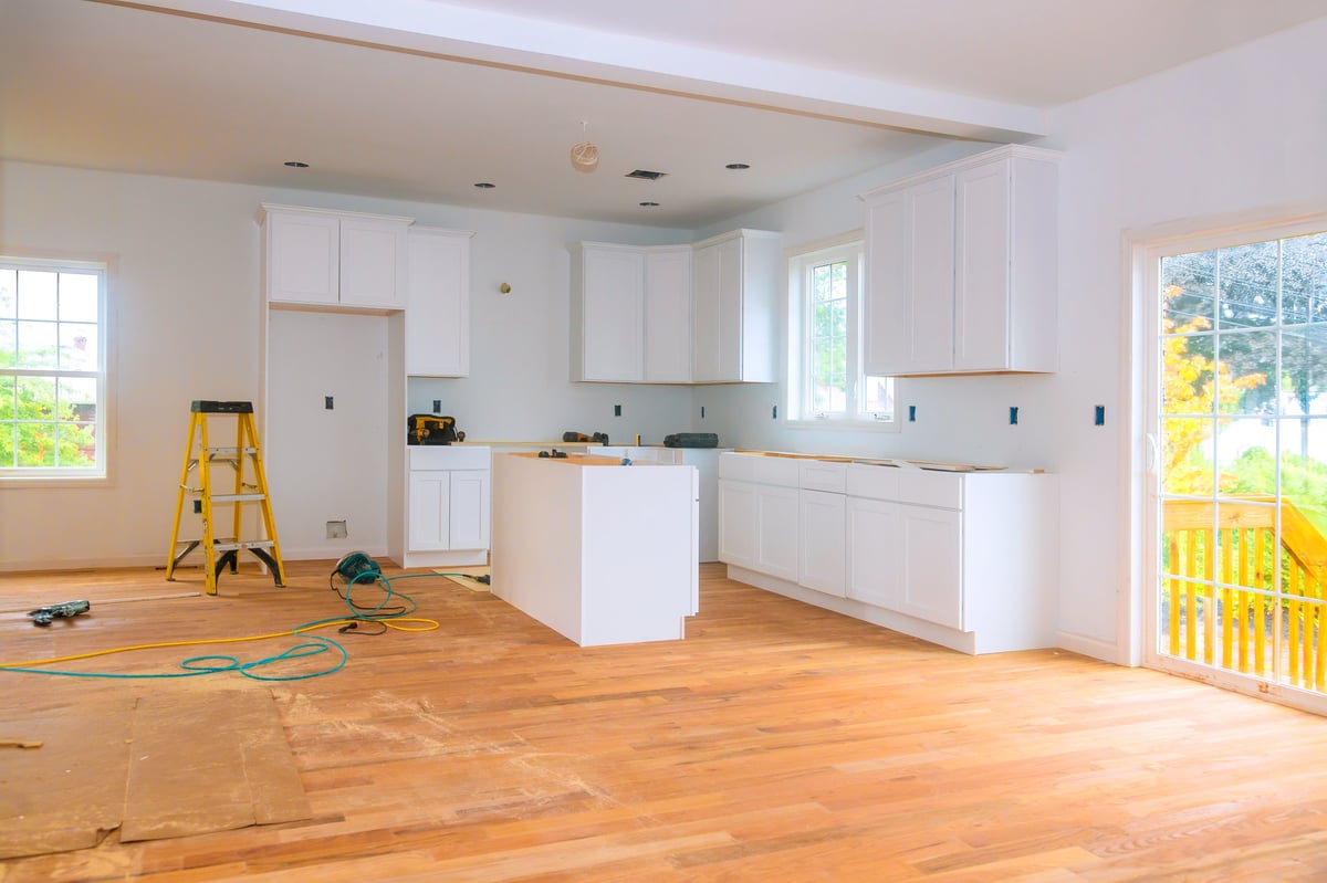 Kitchen Remodel Timeline Texas white cabinets and hardwood flooring during kitchen renovation construction
