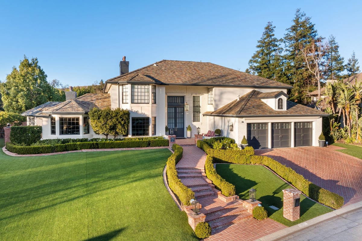 Exterior Painting The Woodlands TX luxury estate with fresh paint manicured lawn and grand curb appeal