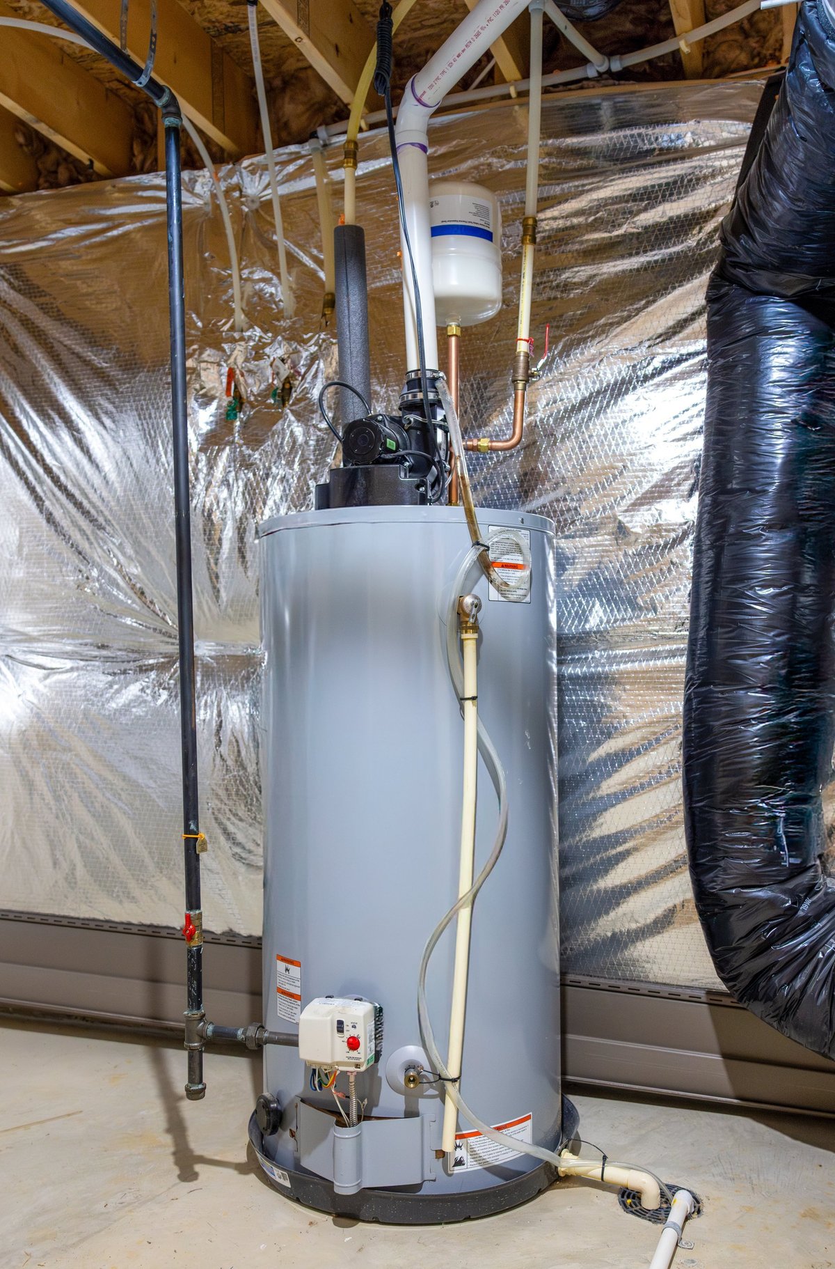 A small water heating unit in a home utility closet