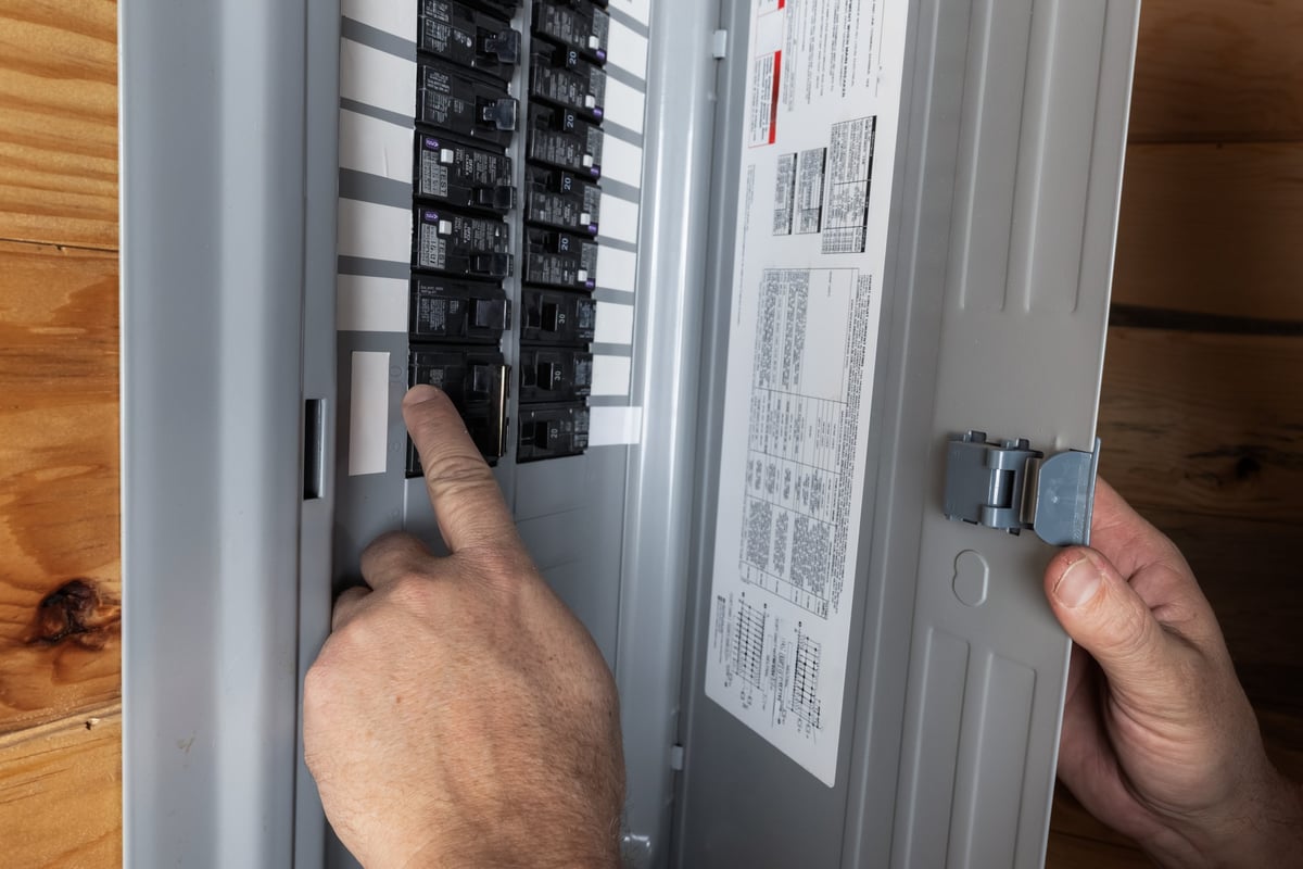 Home owner inspecting electrical breaker panel