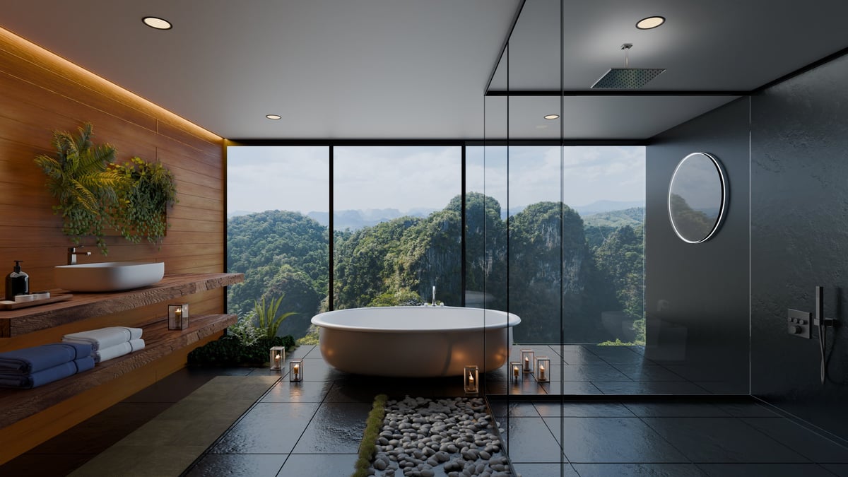 Luxury bathroom with large bathtub, glass wall shower, candles and natural light
