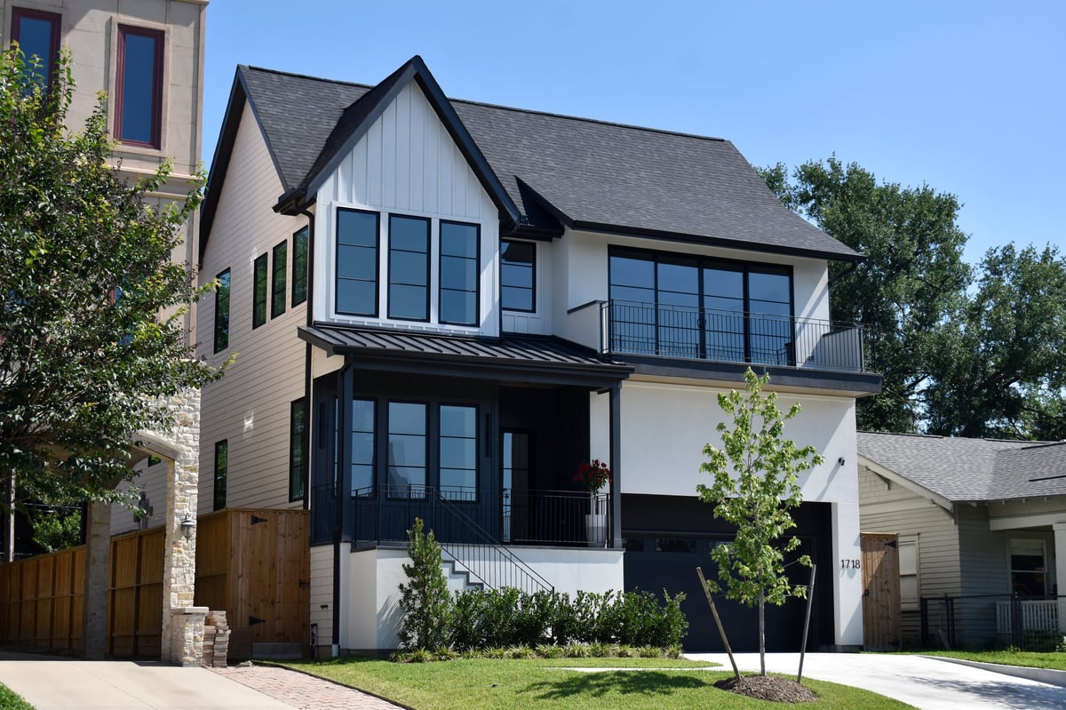 Houston, TX USA - May 12, 2026 - An apparently affluent neighborhood of luxurious modern single-family homes. The clear sky overhead gives this image pleasantly realistic appeal.