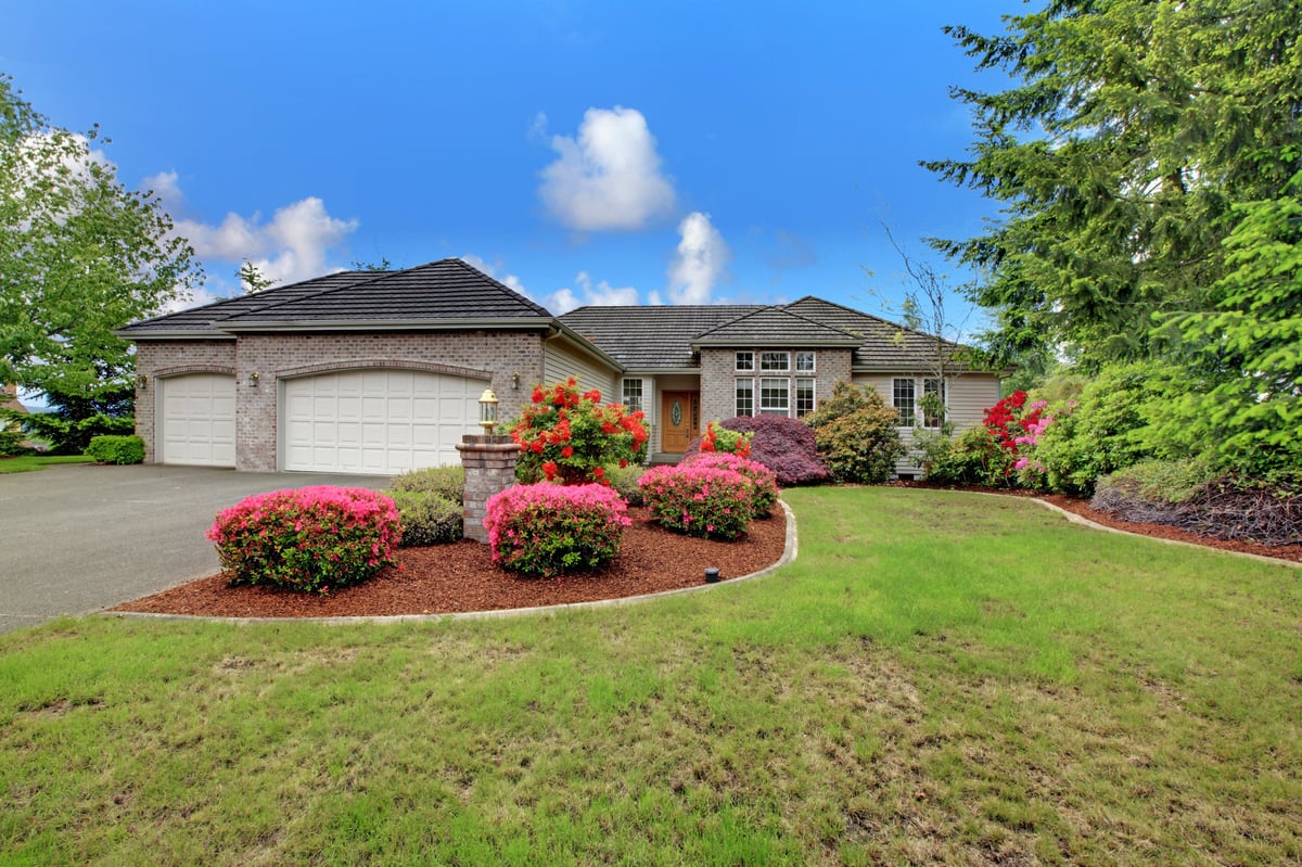 Exterior Painting The Woodlands TX luxury home with fresh exterior paint brick trim and manicured lawn