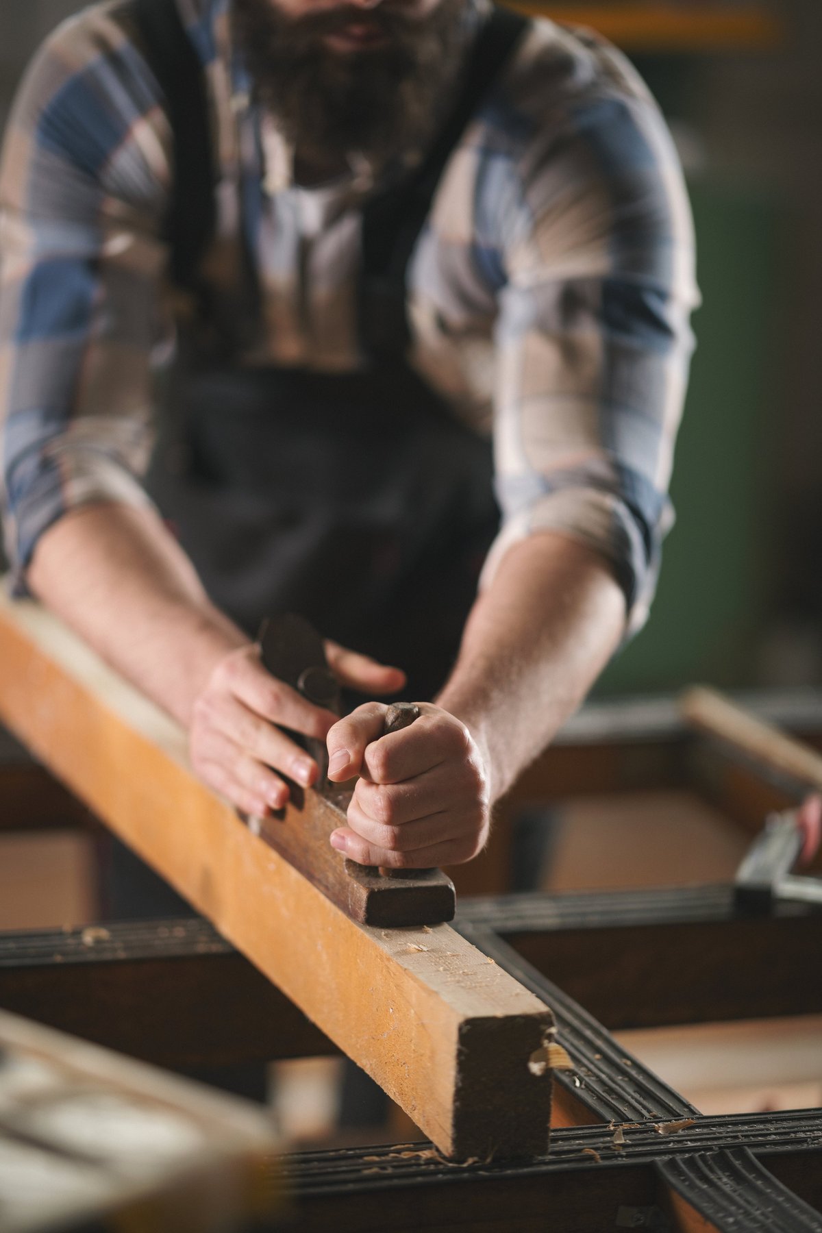 Young carpenter working with wood
